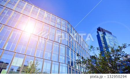 Exterior of modern high-rise buildings in a business district. Tall office buildings. Glass-fronted skyscrapers. Modern business district. Exterior of modern high-rise buildings in a business district. Tall office buildings. Glass-fronted skyscrapers. Modern business district. 132950294