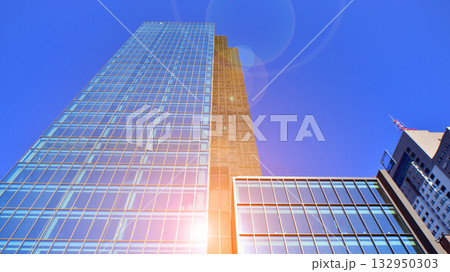 Exterior of modern high-rise buildings in a business district. Tall office buildings. Glass-fronted skyscrapers. Modern business district. 132950303