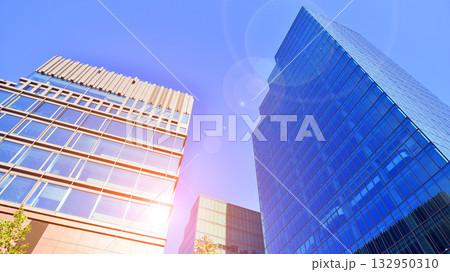 Exterior of modern high-rise buildings in a business district. Tall office buildings. Glass-fronted skyscrapers. Modern business district. 132950310