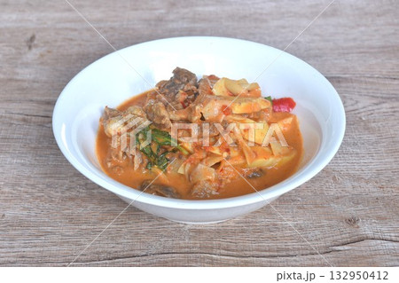 spicy boiled slice fresh bamboo shoot with beef meat topping in coconut milk curry soup on bowl spicy boiled slice fresh bamboo shoot with beef meat topping in coconut milk curry soup on bowl 132950412