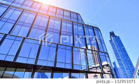 Exterior of modern high-rise buildings in a business district. Tall office buildings. Glass-fronted skyscrapers. Modern business district. Exterior of modern high-rise buildings in a business district. Tall office buildings. Glass-fronted skyscrapers. Modern business district. 132951071