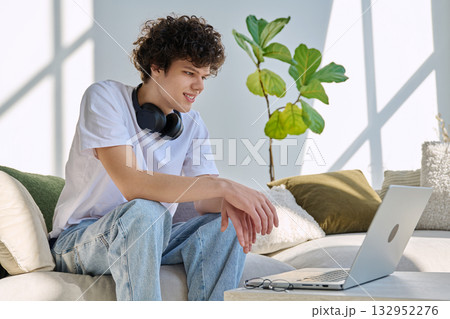 Young man using laptop for video call, online chat conference sitting at home 132952276