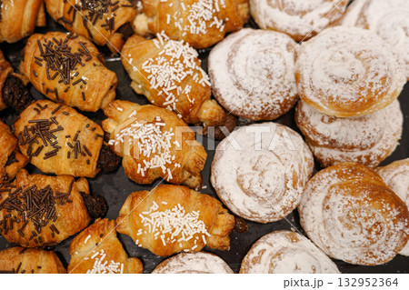 Assortment of ensaimadas and mini croissants on a tray 132952364