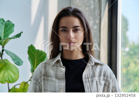Portrait of smiling young teenage girl looking at camera 132952458