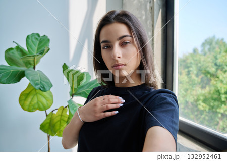 Close-up selfie portrait of teenage female looking at web camera Close-up selfie portrait of teenage female looking at web camera 132952461