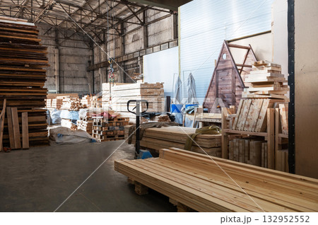 Stacked Wooden Beams and Planks in Warehouse 132952552