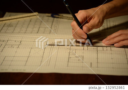 夜に建築図面を製図する日本人建築士の手元 132952861