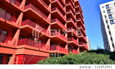 European residential architecture harmonizing with nature. Eco-friendly living in city with greens. Eco apartment building saving energy and fresh air concept. European residential architecture harmonizing with nature. Eco-friendly living in city with greens. Eco apartment building saving energy and fresh air concept. 132952952