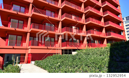 European residential architecture harmonizing with nature. Eco-friendly living in city with greens. Eco apartment building saving energy and fresh air concept. European residential architecture harmonizing with nature. Eco-friendly living in city with greens. Eco apartment building saving energy and fresh air concept. 132952954