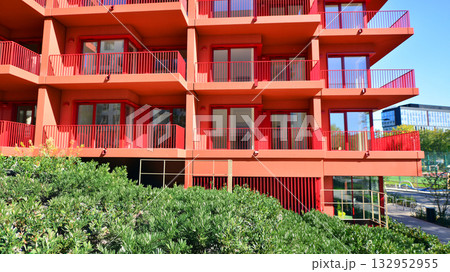 European residential architecture harmonizing with nature. Eco-friendly living in city with greens. Eco apartment building saving energy and fresh air concept.  132952955