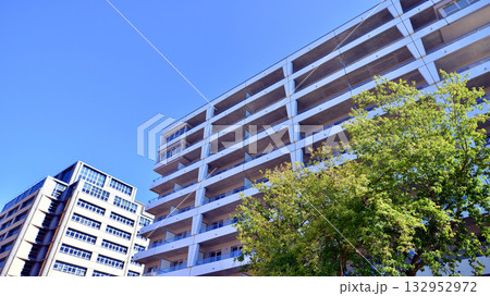 European residential architecture harmonizing with nature. Eco-friendly living in city with greens. Eco apartment building saving energy and fresh air concept.  132952972
