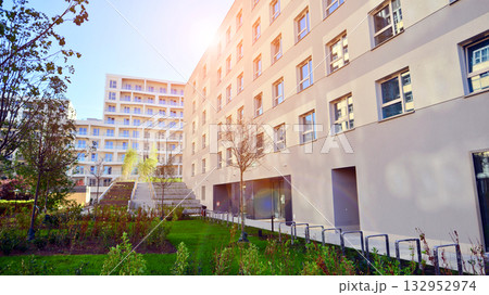 European residential architecture harmonizing with nature. Eco-friendly living in city with greens. Eco apartment building saving energy and fresh air concept.  132952974