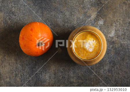 Close up of a warming pumpkin nut latte in a glass on the table top view Close up of a warming pumpkin nut latte in a glass on the table top view 132953010