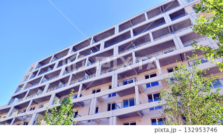 European residential architecture harmonizing with nature. Eco-friendly living in city with greens. Eco apartment building saving energy and fresh air concept.  132953746