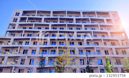 European residential architecture harmonizing with nature. Eco-friendly living in city with greens. Eco apartment building saving energy and fresh air concept. European residential architecture harmonizing with nature. Eco-friendly living in city with greens. Eco apartment building saving energy and fresh air concept. 132953756