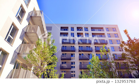 European residential architecture harmonizing with nature. Eco-friendly living in city with greens. Eco apartment building saving energy and fresh air concept.  132953768