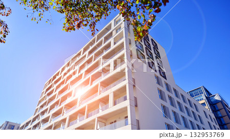 European residential architecture harmonizing with nature. Eco-friendly living in city with greens. Eco apartment building saving energy and fresh air concept. European residential architecture harmonizing with nature. Eco-friendly living in city with greens. Eco apartment building saving energy and fresh air concept. 132953769