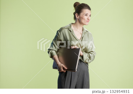 Woman with laptop, slight smirk 132954931