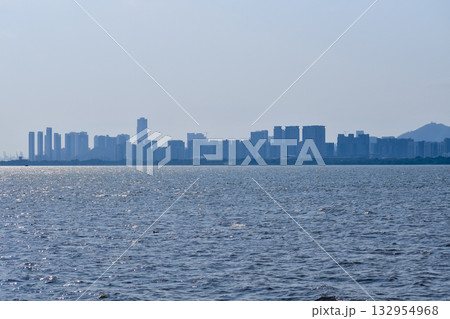 The view Cityscape of Shenzhen, Guangdong, China from the shore of Shenzhen Bay. City in the summer day. Modern city waterfront downtown skyline,China. Nature and landscape. 132954968