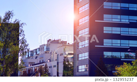 Modern luxury office building.The structure features a glass and concrete walls, showcasing contemporary architecture. The green surroundings of office buildings. Trees and shrubs in the city. 132955237