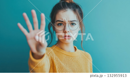 young woman holding up four fingers showing stop sign disapprovi young woman holding up four fingers showing stop sign disapprovi 132955913