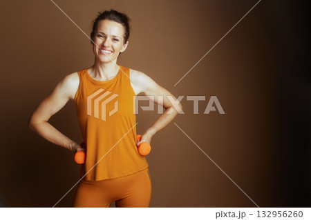 Confident Woman in Mustard Yellow, Hands on Hips 132956260