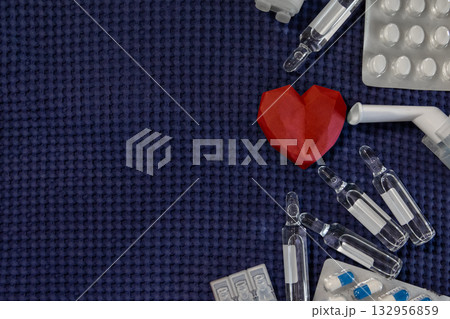 Red heart medical supplies drugs dark blue background Red heart medical supplies drugs dark blue background 132956859