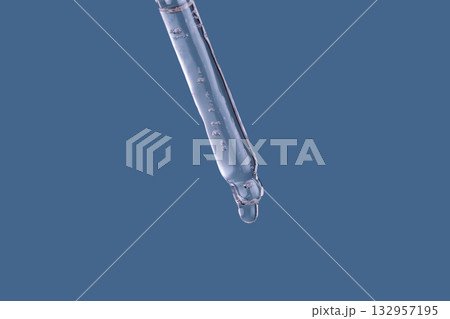 Dropper tip holding liquid chemical drop in laboratory Dropper tip holding liquid chemical drop in laboratory 132957195