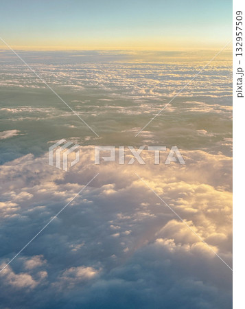View from the airplane window onto the cloudy sky. View from the airplane window onto the cloudy sky. 132957509