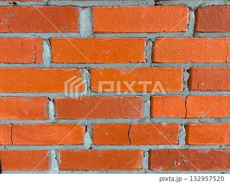 Close-up of a wall made of red brick laid with cement mortar. 132957520