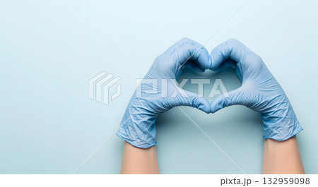 Hands in blue medical gloves forming a heart shape on a light blue background Hands in blue medical gloves forming a heart shape on a light blue background 132959098