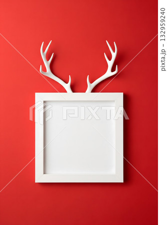 White antlers peeking over a white frame against a vibrant red background 132959240