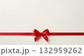 Elegant red ribbon and bow on a cream background, perfect for gifts and celebrations 132959262