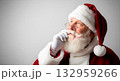 Santa Claus looking up, thoughtful expression, wearing glasses and a red hat 132959266