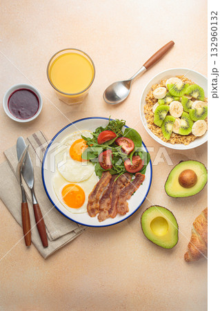 Breakfast warm beige background eggs vegetables salad, oats fruit, croissants, coffee, juice healthy morning. Breakfast warm beige background eggs vegetables salad, oats fruit, croissants, coffee, juice healthy morning. 132960132