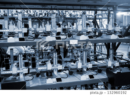 Many 3D printers printing an object. 3D printers simultaneously printing model from molten plastic. Many 3D printers creating shape from molten plastic flowing out of extruder. 3D printing technology 132960192