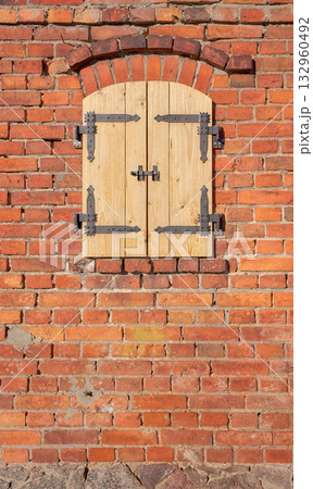 Old brick wall with new wooden shutters. 132960492