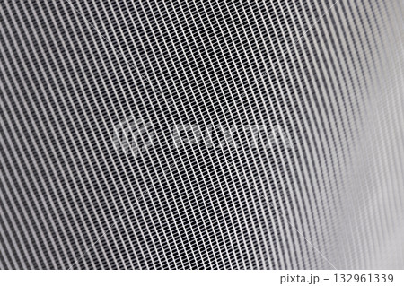 fabric for white tulle or curtains close up, finely woven synthetic threads for making tulle for windows in the home 132961339