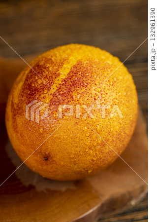 ripe red-orange oranges with juicy flesh covered with drops of water on a wooden table, fresh sweet and wet oranges with an unusual red color on the table ripe red-orange oranges with juicy flesh covered with drops of water on a wooden table, fresh sweet and wet oranges with an unusual red color on the table 132961390