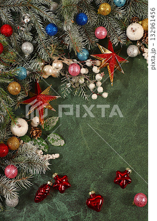 Beautiful Christmas and New Year background with live snowy fir branches, decorations and toys, product design for holiday advertising, Christmas Eve concept, festive winter card and banner 132961456