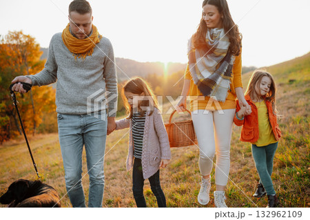 Happy young family with two children in autumn nature at sunset. 132962109