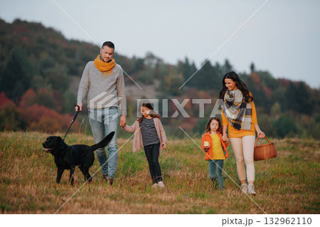 Happy young family with two children in autumn nature at sunset. 132962110