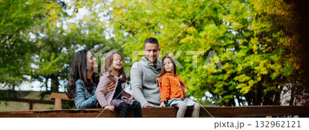 Family enjoing beautiful view during walk, warm autumn day. 132962121