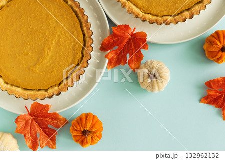 Festive Pumpkin Pie with Autumn Leaves, Decorative Pumpkins, and Gold Cutlery 132962132