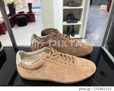 Brown beige sneakers with laces on store counter Brown beige sneakers with laces on store counter 132962153