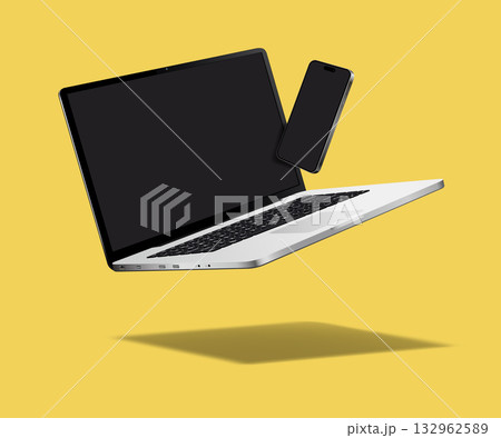 Falling laptop and smartphone isolated on yellow background Falling laptop and smartphone isolated on yellow background 132962589