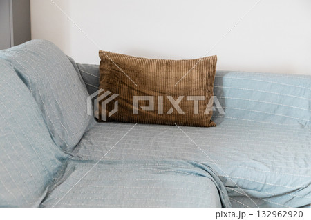 Brown cushion on sofa. Comfort, softness, and relaxed domestic rhythm of peaceful moments. Brown cushion on sofa. Comfort, softness, and relaxed domestic rhythm of peaceful moments. 132962920