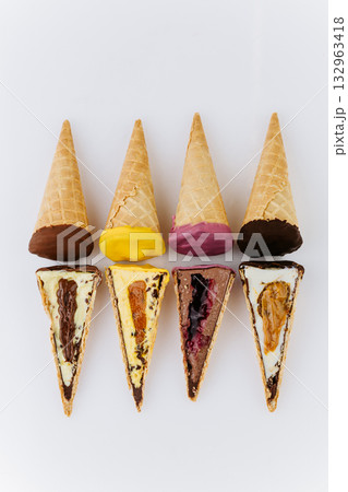 Assorted ice cream cones and slices with colorful toppings on white background Assorted ice cream cones and slices with colorful toppings on white background 132963418
