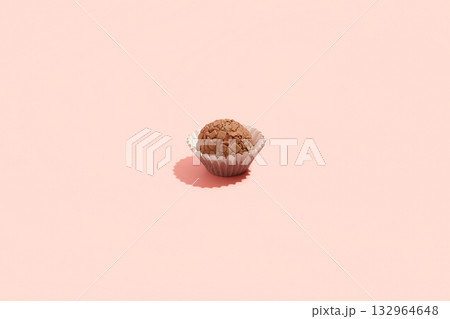 Typical Brazilian sweet brigadeiro. One cocoa candy on a pink background Typical Brazilian sweet brigadeiro. One cocoa candy on a pink background 132964648