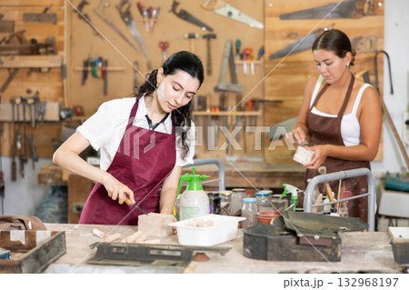 Girl is busy in carpentry workshop Girl is busy in carpentry workshop 132968197
